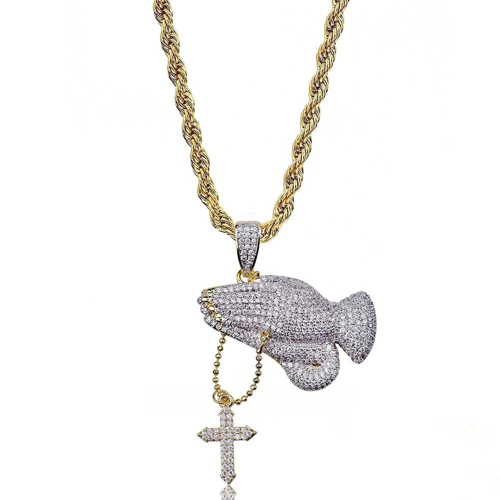 Iced two tone blessing praying hands pendant with dangling cross charm paired with gold rope chain, fully set flawless VVS simulated diamonds, copper 18k gold plated men hip hop faith bling jewelry isolated on clean white background RDRIP JEWELRY

