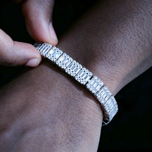 Real wear shot of men's 8mm rectangular baguette cut VVS1+ D color moissanite tennis bracelet worn on dark tone brown skin wrist, solid S925 sterling silver with white gold & 18K gold plating, hand set layered baguette and round moissanite stones with icy brilliant sparkle, tarnish resistant hip hop streetwear stacking bracelet, passes standard diamond tester, available in 7 inch and 8 inch sizes luxury diamond substitute wrist jewelry for rappers street style RDRIP JEWELRY Since 2016
