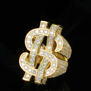 RDRIP JEWELRY Dollar Tycoon hollow double US dollar sign ring 18k gold plated, angled side close‑up view, densely paved AAA cubic zirconia stones, interlocked double dollar symbol hip hop men bling statement ring, sparkling icy effect shot on black reflective background
