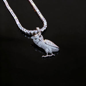 Iced Out Full Pave 3D Owl Pendant necklace, top‑down overhead view, fully micro paved cubic zirconia owl charm paired with tennis chain, sharp mirror reflection on solid black glossy reflective board, premium iced hip hop animal jewelry for men RDRIP JEWELRY

