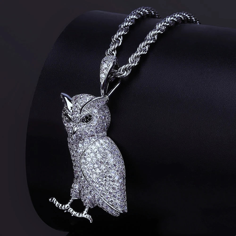 Iced Out Full Pave 3D Owl Pendant paired with twisted rope chain, fully encrusted micro pave cubic zirconia owl charm, close up shot on curved black leather display cushion, premium hip hop bling animal pendant necklace for men RDRIP JEWELRY
