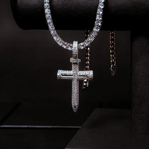 Hanging displayed Iced Out Nail Cross Pendant full pave AAA cubic zirconia silver tone nail crucifix necklace for men, premium bling hip hop street jewelry paired with tennis chain against deep pure black background RDRIP JEWELRY
