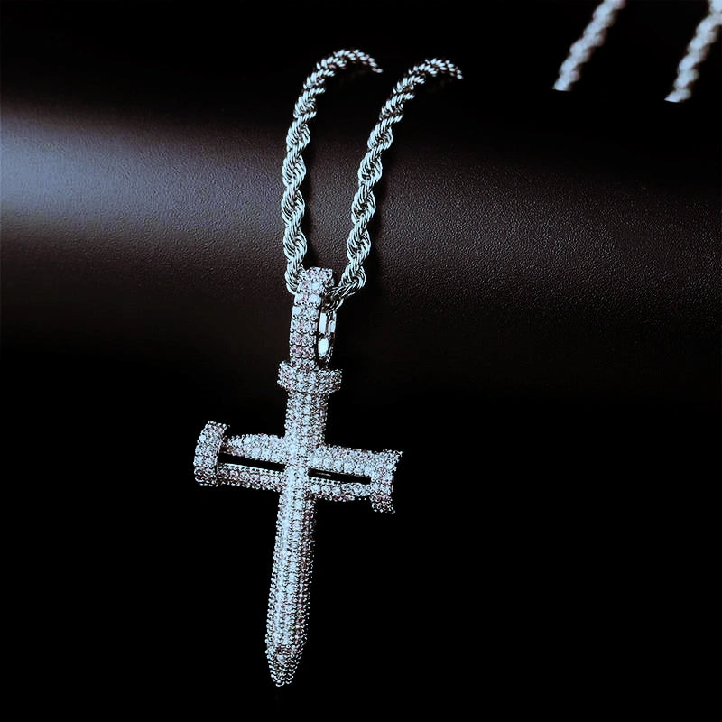 Hanging view silver tone Iced Out Nail Cross Pendant, full pave AAA cubic zirconia nail shaped crucifix pendant for men, paired with twisted rope chain displayed on smooth dark black background RDRIP JEWELRY
