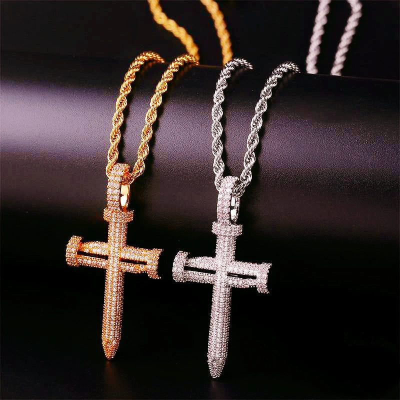 Side by side compare view Iced Out Nail Cross Pendant in 18k gold plated and silver tone, full pave AAA cubic zirconia nail crucifix men hip hop necklace matched with rope chain on dark black background RDRIP JEWELRY
