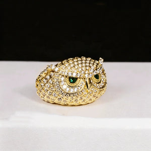 Studio shot of single 18K gold plated Iced Owl King Ring, intricate owl scale texture, striking emerald green eyes, full micro‑paved flawless VVS simulated diamonds, heavy iced out hip hop mens statement ring on clean white display surface RDRIP JEWELRY
