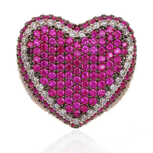 Macro close‑up view of magenta pink iced out pave love heart ring, densely hand‑set AAA cubic zirconia stones with sparkling clear CZ border detail, full micro pave heart‑shaped hip hop bling ring, thick statement ring surface, isolated clean white background, unisex luxury street wear rapper jewelry for men women RDRIP JEWELRY

