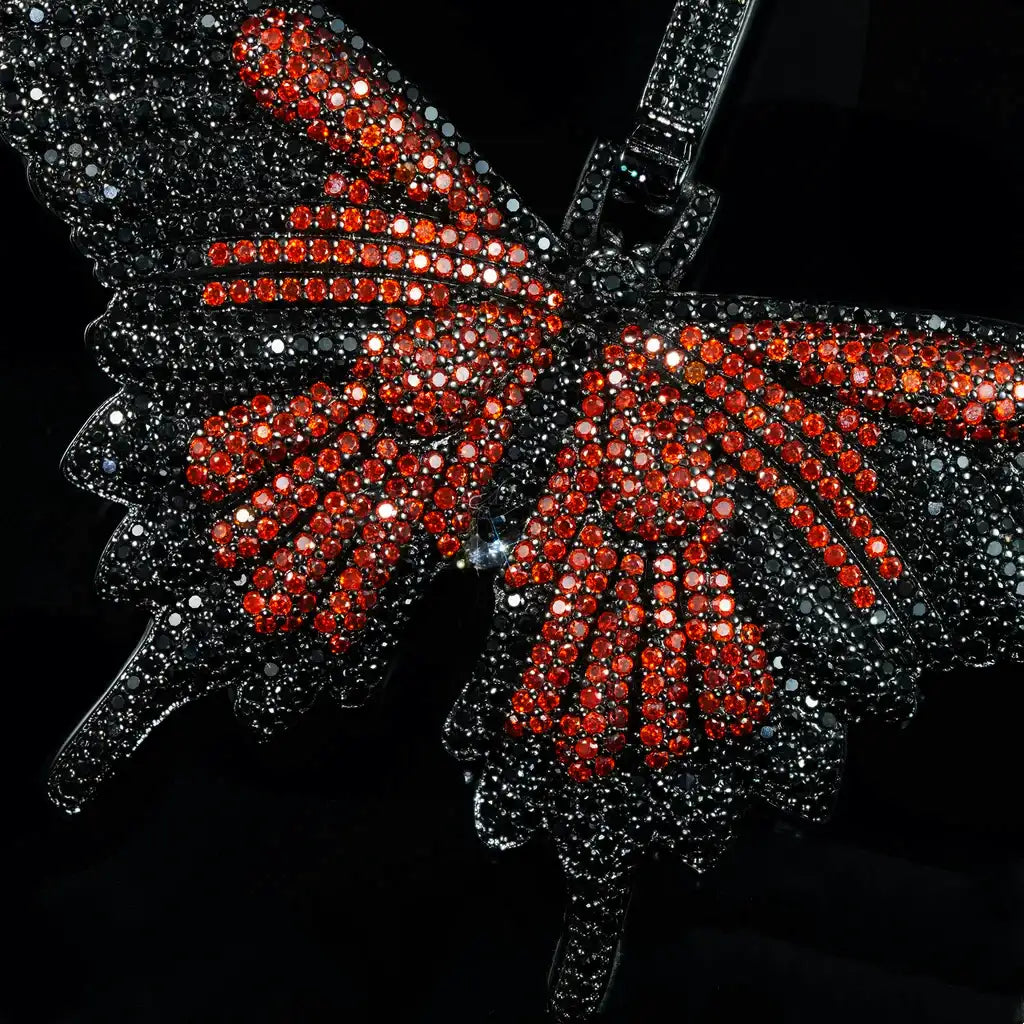 Micro‑pave iced out orange black butterfly pendant necklace black gunmetal finish close up view full paved flawless VVS simulated diamonds hip hop bling street jewelry for men women RDRIP JEWELRY
