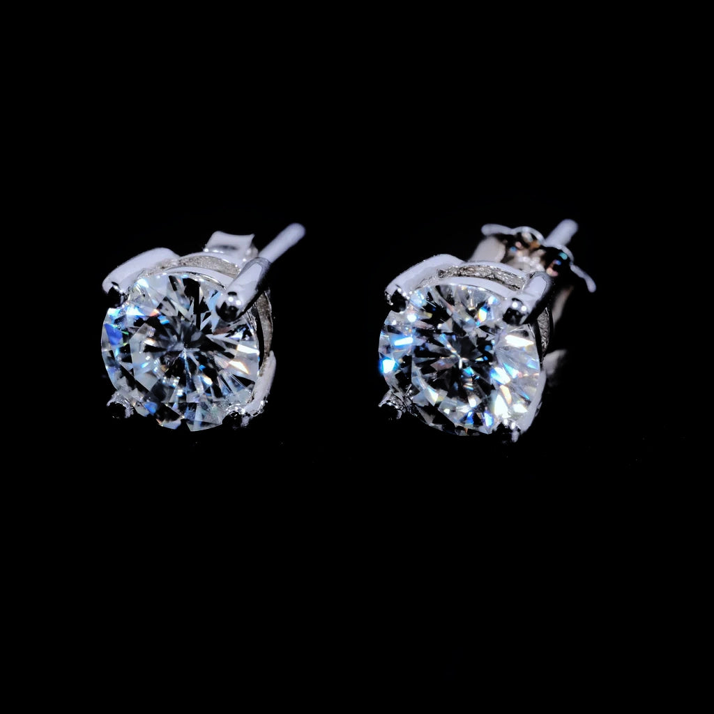 Minimalist Solitaire Round Moissanite Stud Earrings, 4-prong setting D-E color VVS1 hearts and arrows round moissanite, 925 sterling silver white gold plated unisex hip hop single stone earrings front close-up shot on solid black background RDRIP JEWELRY
