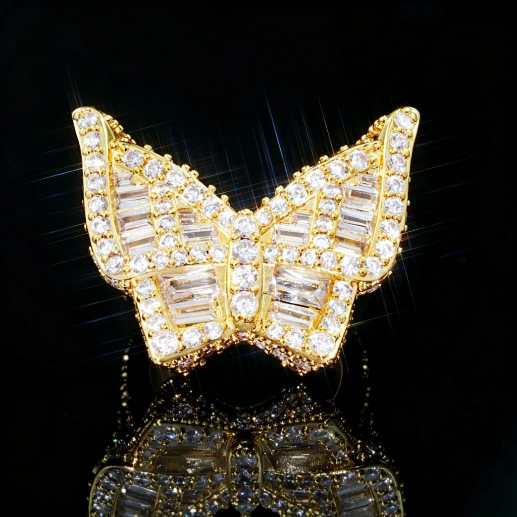 Gold plated oversized 3D butterfly iced ring front close up view full micro pave baguette aaa cubic zirconia bling hip hop men statement jewelry sparkling stones black reflective background RDRIP JEWELRY
