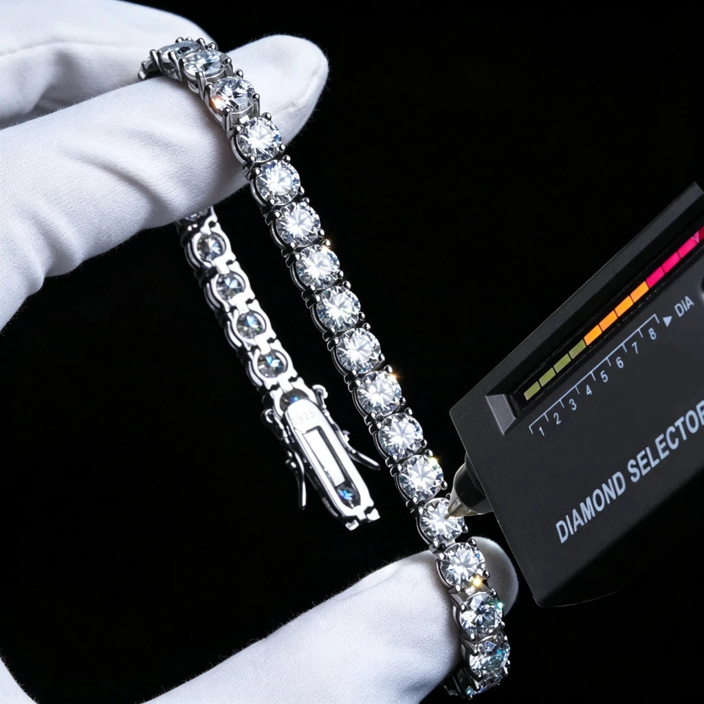 Studio shot of round brilliant cut VVS1 D color moissanite tennis bracelet crafted from S925 sterling silver, held gently by clean white cotton jewelry gloves, professional diamond selector tester touching moissanite stone showing positive diamond test result, visible engraved S925 marking on double lock safety clasp, fully hand-set sparkling moissanite stones with strong light reflection bling, solid pure black minimalist background, hip hop fashion wrist chain accessory for men and women