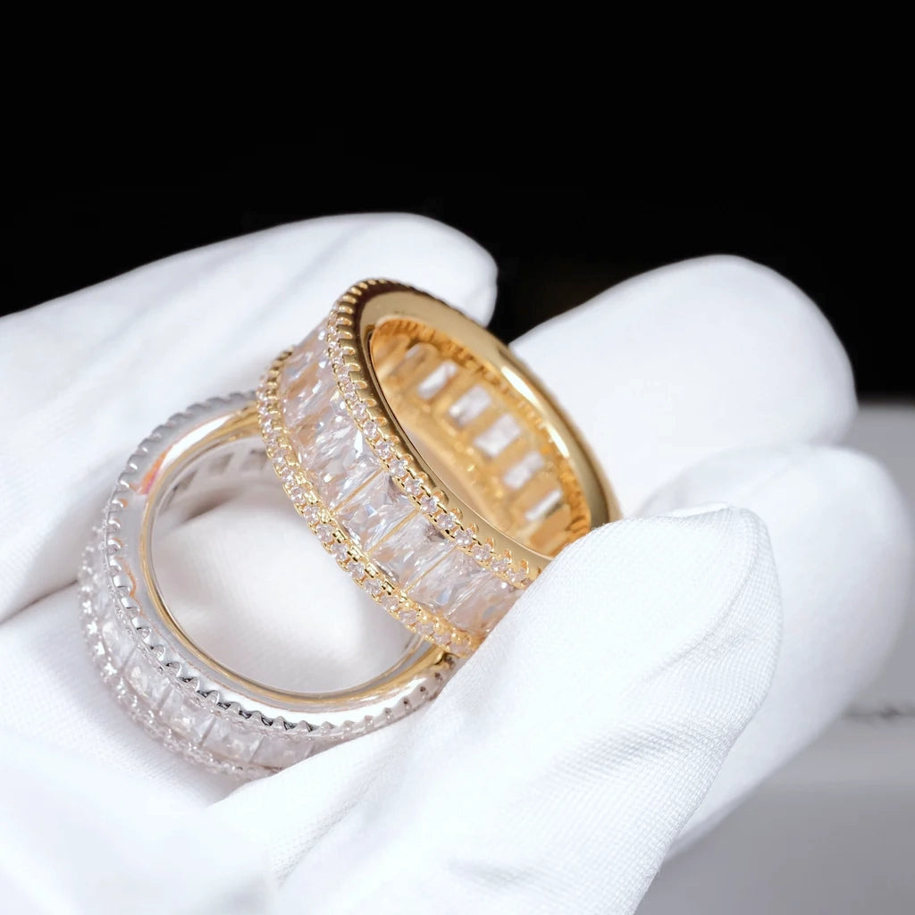 Gold and white gold plated wide baguette eternity ring double sided micro pave 8mm band flawless VVS simulated diamonds two styles men hip hop bling rings held in white cotton glove closeup product shot RDRIP JEWELRY
