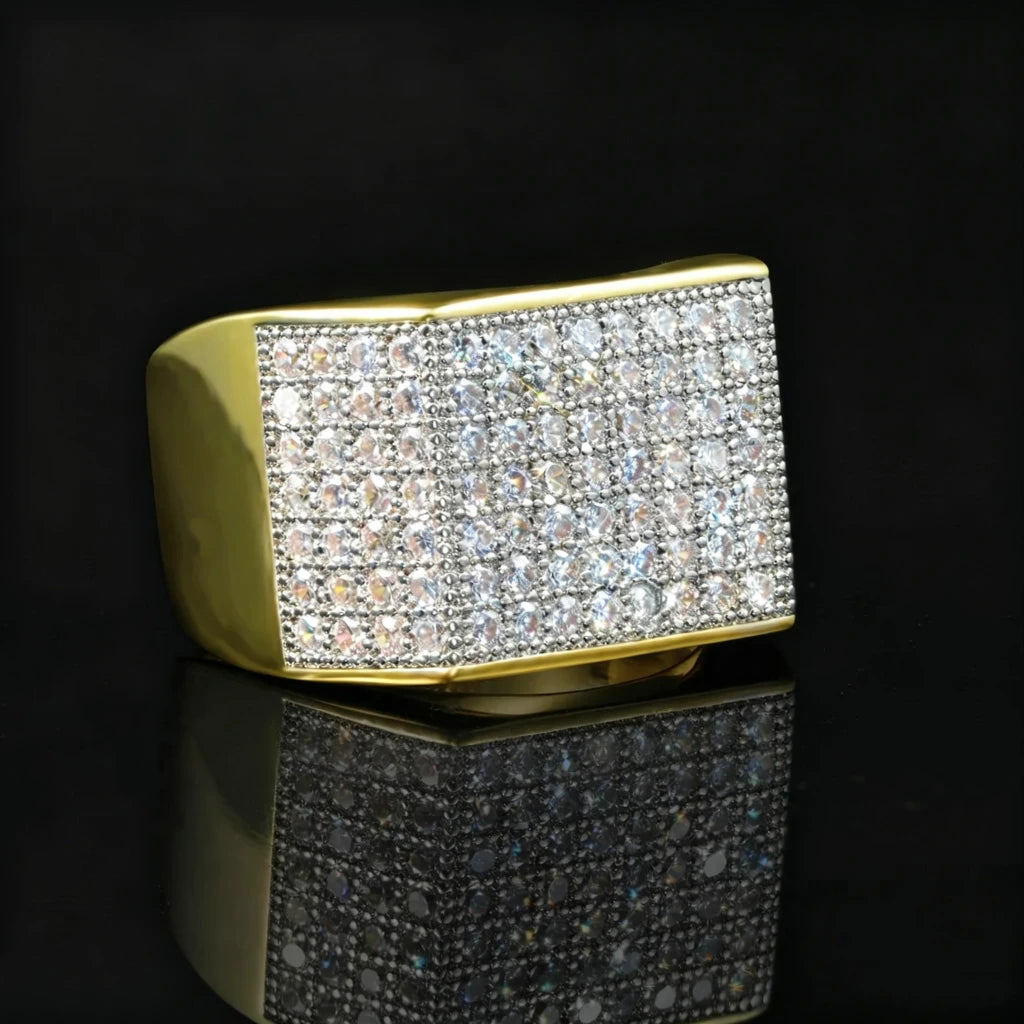 Angled side view of two‑tone gold silver men hip hop full pave square statement band ring by RDRIP JEWELRY, thick polished gold band with densely hand‑set cubic zirconia and rhinestone pave stones, 18k gold plated copper heavy iced‑out bling mens hip‑hop statement ring, black glossy reflective studio product photography
