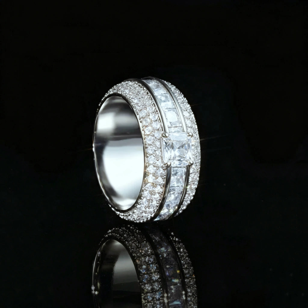 Side profile view of silver tone baguette princess cut triple band spinner eternity ring for men, hand set aaa cubic zirconia micro pave stones, shiny iced out wide hip hop statement band ring displayed on black glossy reflective background, luxury mens bling jewelry RDRIP JEWELRY SINCE 2016
