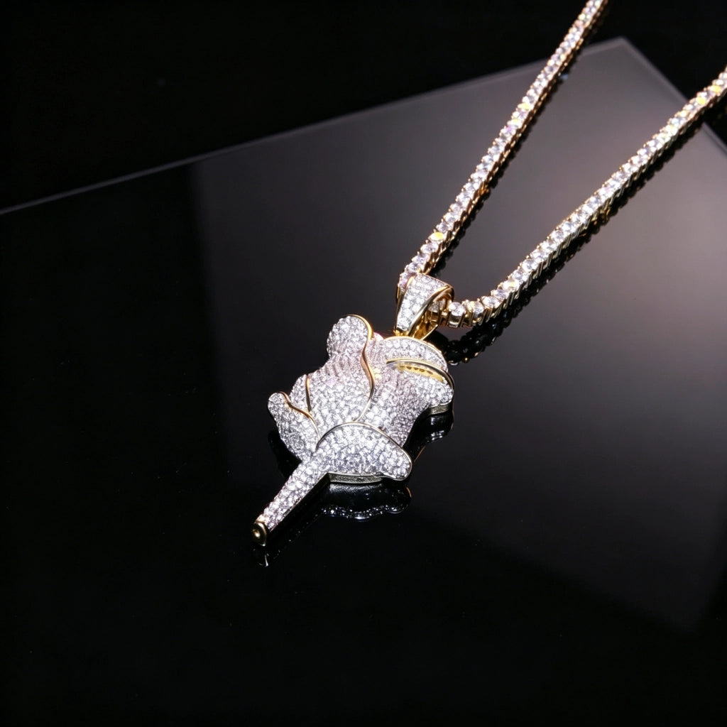 Closeup shot of bling fully paved rose flower pendant resting on black reflective surface, iced out gold plated hip hop necklace embedded with flawless vvs simulated diamonds, premium unisex hiphop streetwear pendant jewelry RDRIP JEWELRY SINCE 2016
