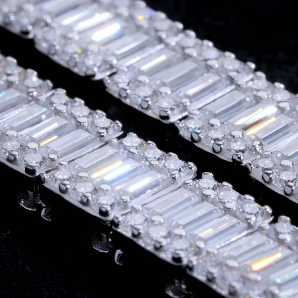 Macro close-up detail shot of 8MM rectangular baguette cut VVS1+ D color moissanite tennis link chain, solid S925 sterling silver white gold finish, hand prong set clear baguette moissanite surrounded by round accent moissanite stones, ultra high clarity brilliant light reflection and rainbow sparkle, 9.25 mohs hardness genuine moissanite not cubic zirconia or diamond simulants, premium hip hop bling necklace craftsmanship closeup, stacked baguette stone structure detail for men streetwear jewelry, luxury i