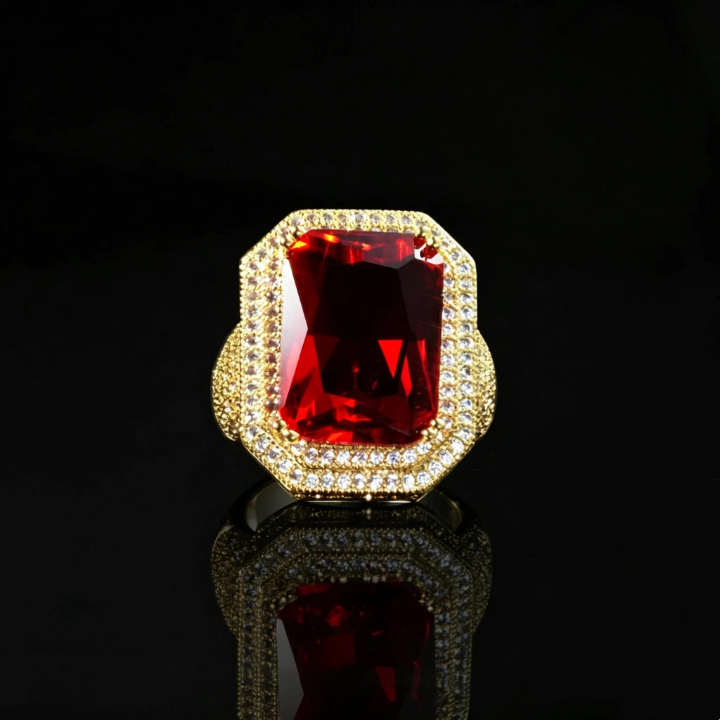 Front view shot of men’s heavy iced‑out hip‑hop statement ring, large emerald‑cut deep vivid red gemstone center, double‑layer halo with hand‑set micro pave sparkling stones, premium 18K gold‑plated ornate frame, wide chunky band, luxury bling hip hop men jewelry, black glossy reflective surface product photography RDRIP JEWELRY
