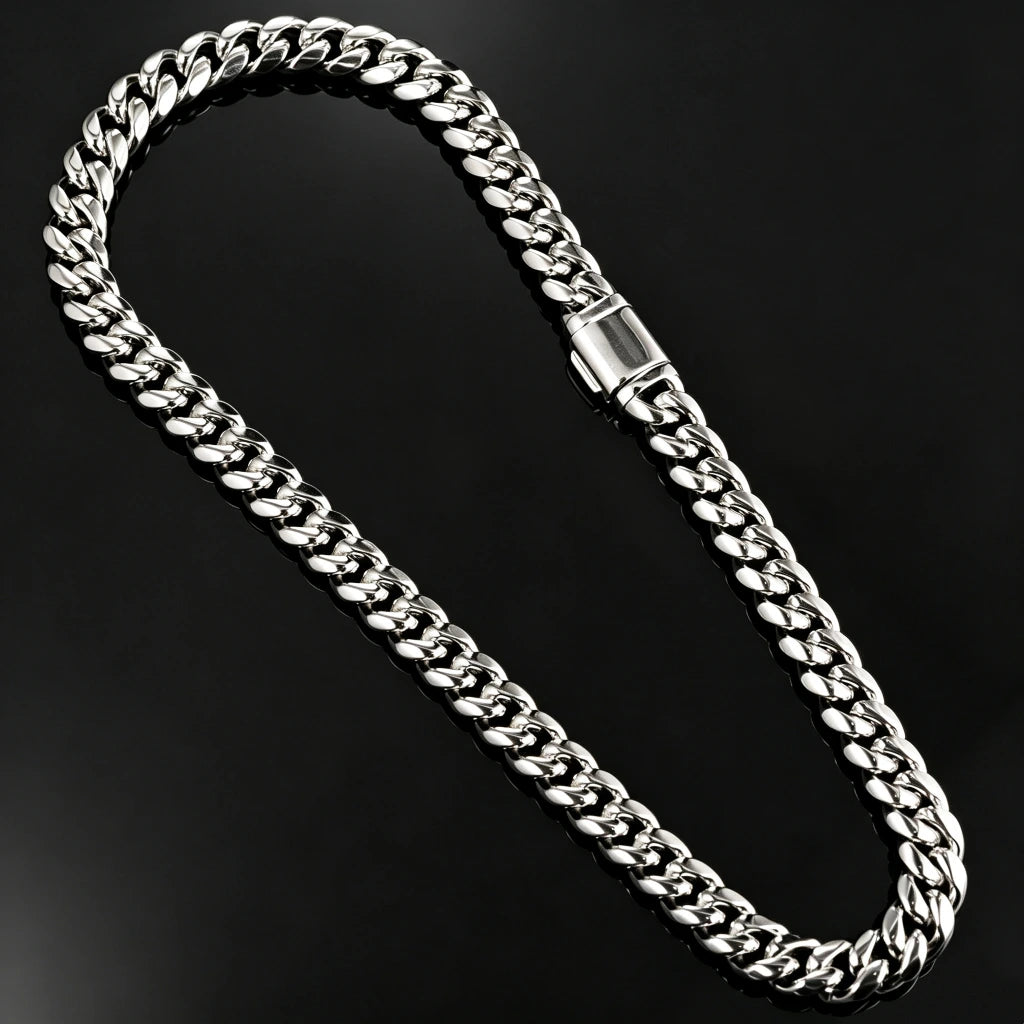 Top-down studio flat lay photo of full length 12.2mm polished 14k white gold plated Miami Cuban link chain with sturdy rectangular box lock clasp, seamless solid black single-piece reflective mirror backdrop with zero color blocks, thick tight interlocking curb links, mirror-like shiny silver anti-tarnish finish, heavy solid metal plain hip hop curb necklace for men, no stones minimalist luxury men bling jewelry product shot RDRIP JEWELRY SINCE 2016
