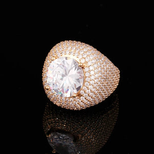 Profile angle shot of men hip‑hop Glory Dome Iced Clustered Band Ring in 18K gold plated finish, large round brilliant cut center stone secured by gold four prongs, layered micro pave hand‑set VVS flawless simulated diamonds full dome band, heavy luxury gold bling statement ring for men, displayed on black reflective dark background RDRIP JEWELRY
