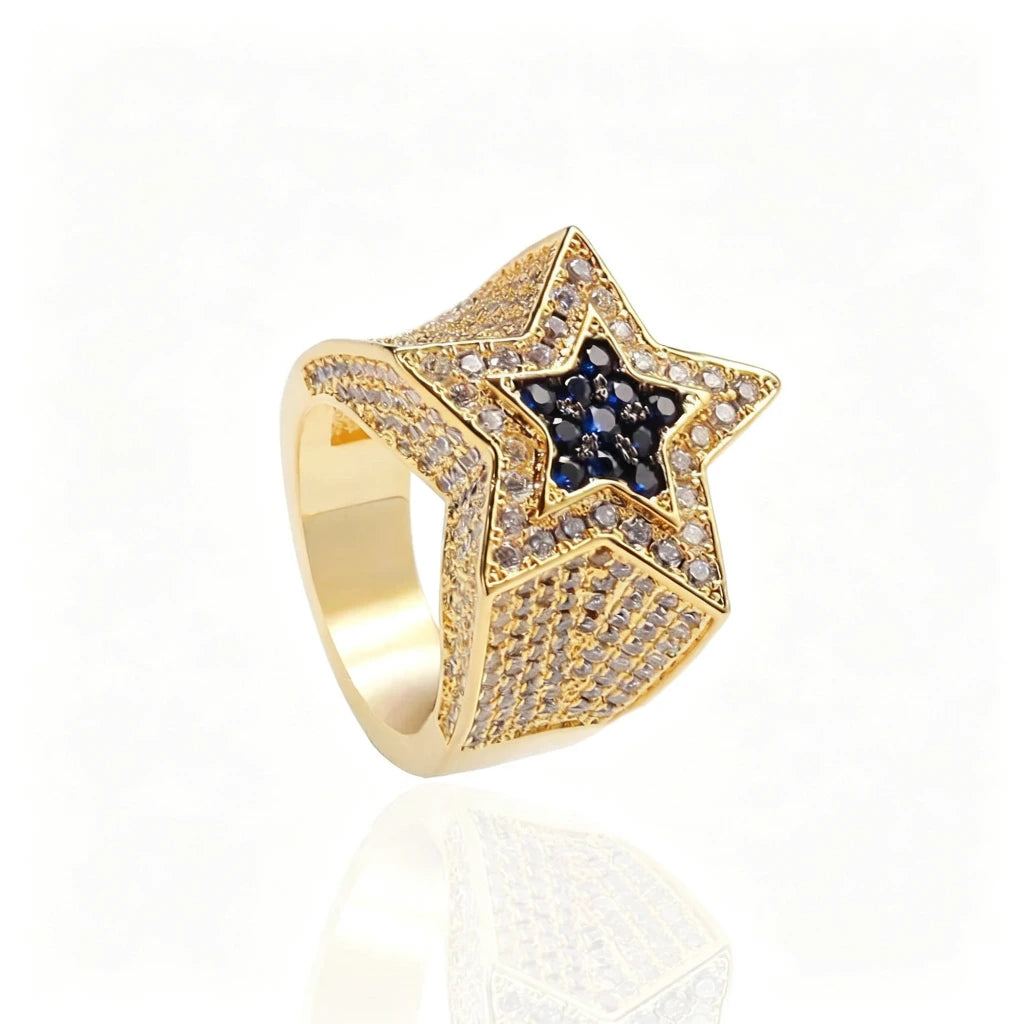 Studio product shot of men’s gold‑plated iced out double pentagram star hip hop ring, hand‑set AAA white cubic zirconia pave setting with deep royal blue CZ star center, heavy wide polished band, clean white background with soft reflection, luxury bling rap statement jewelry for men, perfect for party wear and holiday gift from RDRIP JEWELRY
