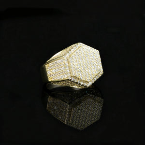 Gold plated men hip hop hexagon signet ring full micro‑inlay pave set sparkling cubic zirconia stones icy bling geometric hexagonal rapper statement ring polished gold metal angled product photograph with clear mirror reflection on glossy black surface RDRIP JEWELRY
