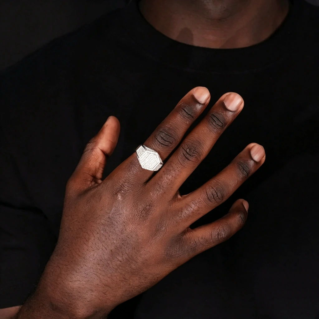 Silver finish hexagon iced out pave micro‑inlay men signet ring worn on black man hand model showcase photo full pave cubic zirconia icy bling hexagonal hip hop rapper statement jewelry real wear effect dark background men fashion accessory RDRIP JEWELRY
