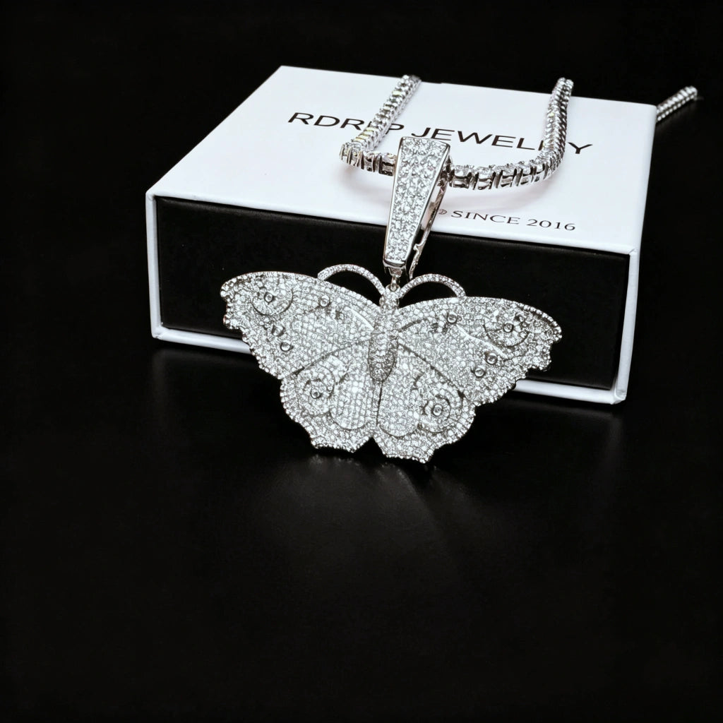 Iced Out Large Vintage Butterfly Pendant side shot placed with RDRIP branded gift box, full pave AAA cubic zirconia micro inlay hip hop bling charm, 18k gold plated copper statement necklace for men and women RDRIP JEWELRY SINCE 2016
