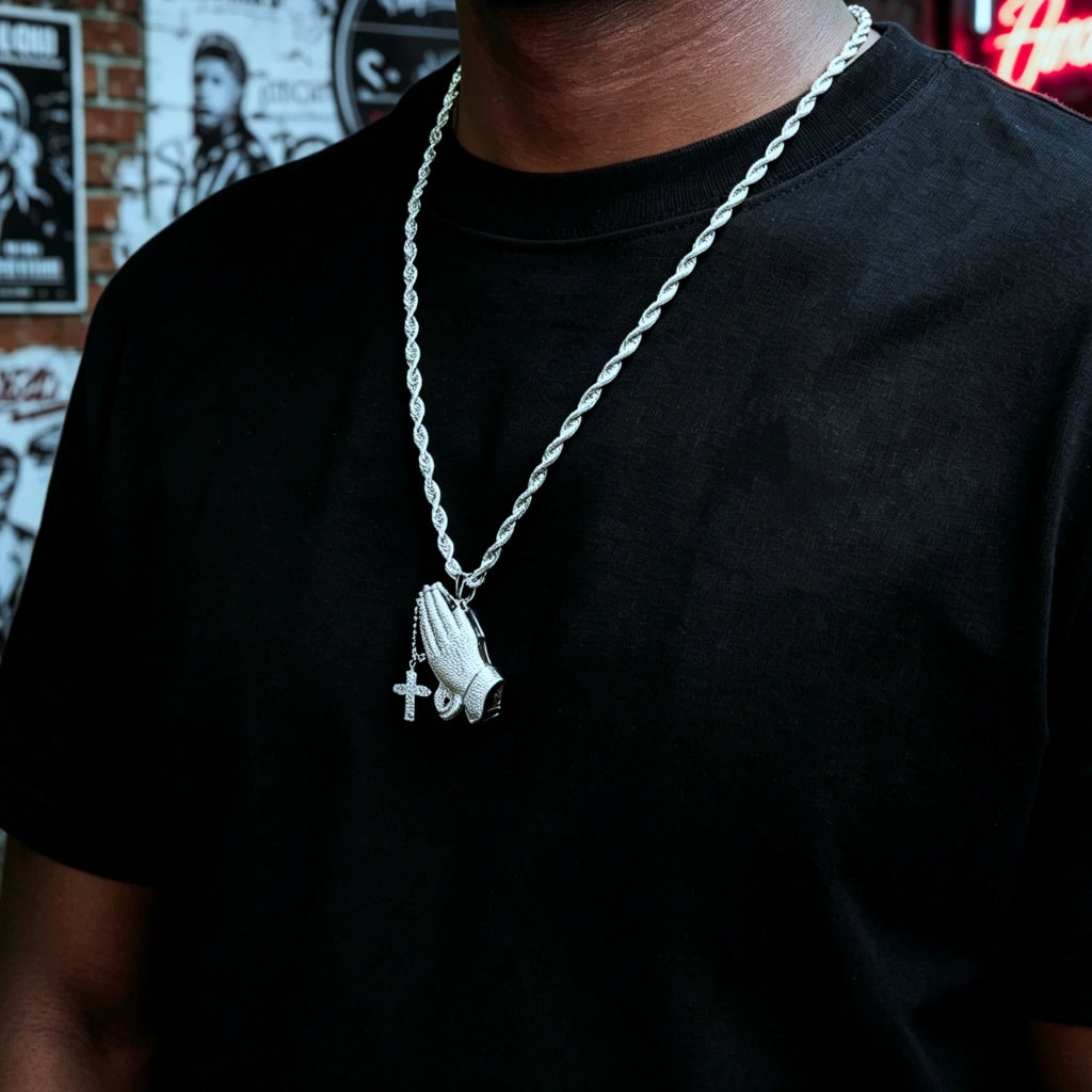 Black male model wearing iced out praying hands pendant with dangling cross on rope chain, s925 silver white gold plated vvs simulated diamonds hip hop faith necklace street style men fashion bling jewelry RDRIP JEWELRY
