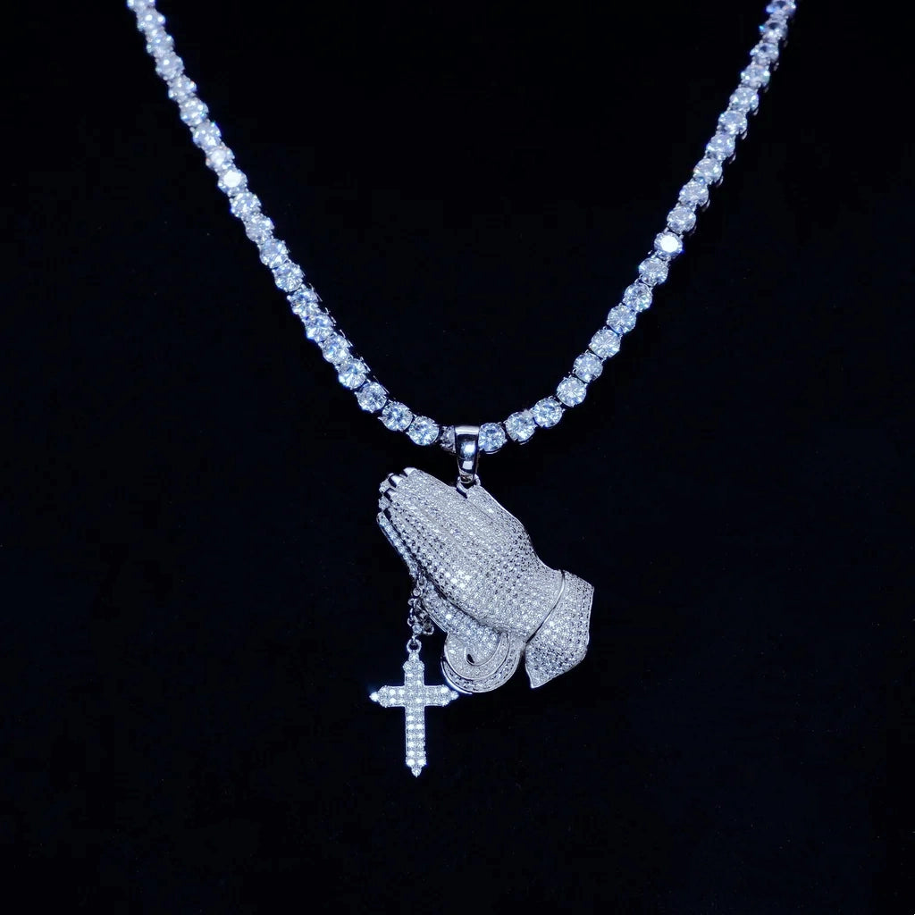 Iced out praying hands pendant with dangling cross charm paired with tennis chain, s925 silver white gold plated fully set vvs simulated diamonds, hip hop bling religious mens necklace dark studio background luxury street jewelry RDRIP JEWELRY
