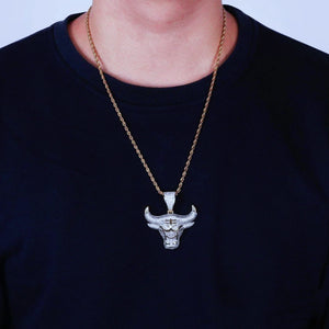 Men model wearing two tone 18k gold plated iced out bull head pendant necklace with 24 inch gold rope chain, micro paved cubic zirconia icy ox charm, real‑wear hip hop street style mens jewelry RDRIP JEWELRY SINCE 2016
