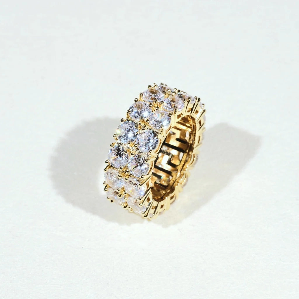 Iced micro pave double row gold plated band ring on light white background, hand‑set prong‑lifted cubic zirconia full icy eternity ring for men women, brilliant sparkling bling hip‑hop statement jewelry ideal for streetwear club and daily wear RDRIP JEWELRY
