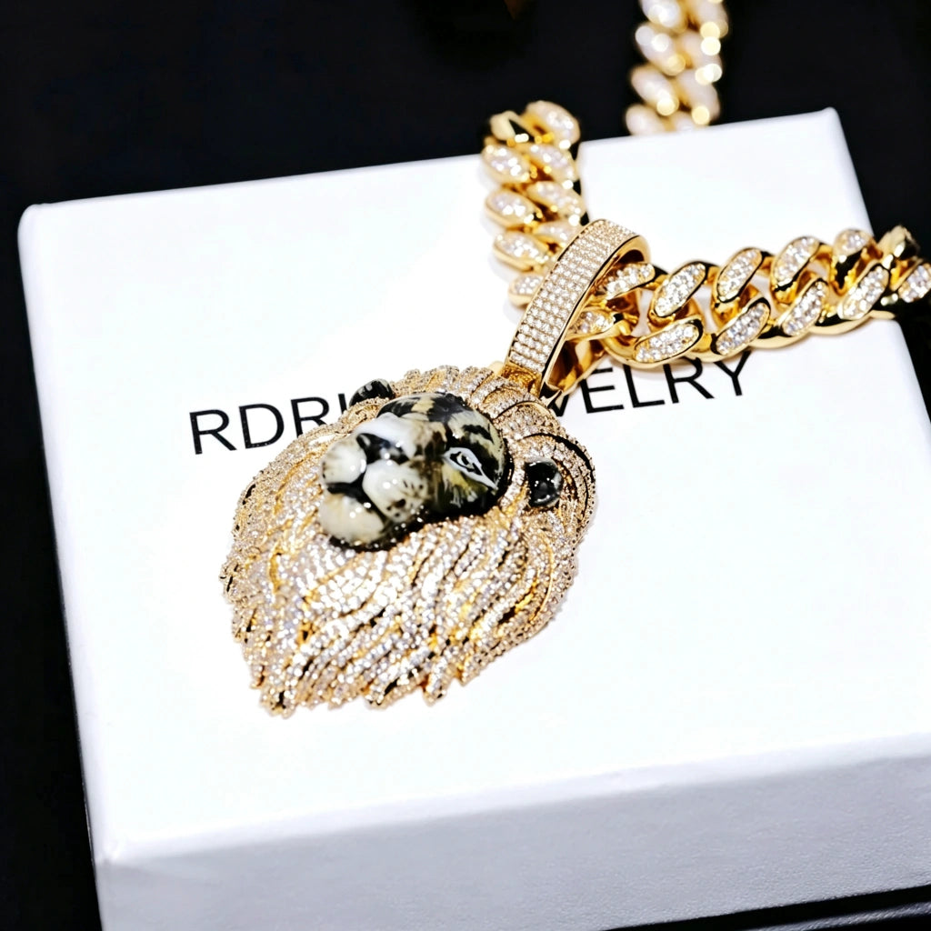 Gold iced out 3D enamel painted lion king pendant side angle shot, realistic hand‑painted lion facial details, vvs simulated diamond covered mane and bail, paired with iced cuban link chain, premium men hip hop jewelry displayed on branded gift box RDRIP JEWELRY
