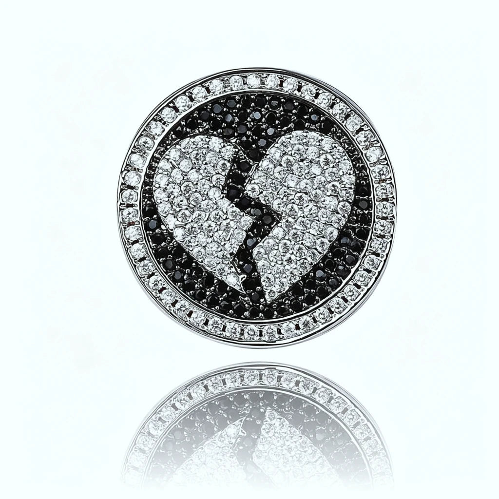 Close up top view Iced Out Heartbreak Signet Ring black white pave simulated diamond broken heart design circular signet face mirror reflection on clean white background hip hop mens bling jewelry RDRIP JEWELRY