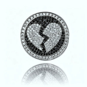 Close up top view Iced Out Heartbreak Signet Ring black white pave simulated diamond broken heart design circular signet face mirror reflection on clean white background hip hop mens bling jewelry RDRIP JEWELRY