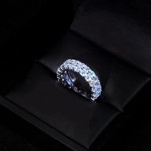 6mm double‑row full pave moissanite eternity ring resting inside open black satin luxury jewelry gift box, hand‑set D‑Color VVS1+ 4mm round hearts‑and‑arrows moissanite stones, polished 925 sterling silver white gold plated icy hip‑hop unisex bling ring, brilliant rainbow light reflections and sparkling facets, premium gifting‑ready statement jewelry for men and women RDRIP JEWELRY SINCE 2016
