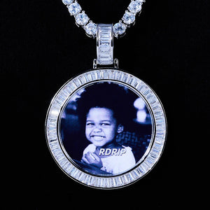 Baguette Iced Out Round Custom Photo Pendant Necklace, white gold tone round medallion with baguette stone frame, custom black and white child portrait photo, matched tennis chain, solid black background studio shot, personalized hip hop memory jewelry, RDRIP JEWELRY
