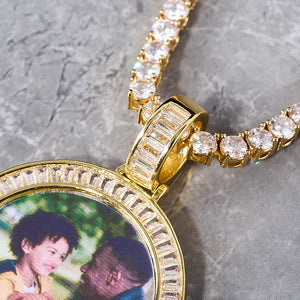 Baguette Iced Out Round Custom Photo Pendant Necklace, close-up detail shot of yellow gold pendant with hand-set baguette stones on the bail and frame, custom family portrait photo, tennis chain, grey marble texture background, personalized hip hop custom jewelry, RDRIP JEWELRY
