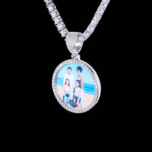Classic Iced Out Circle Custom Photo Pendant Necklace, silver tone circular family photo medallion with single row stone frame, paired with tennis chain, studio shot on solid black background, personalized hip hop memory keepsake jewelry, RDRIP JEWELRY

