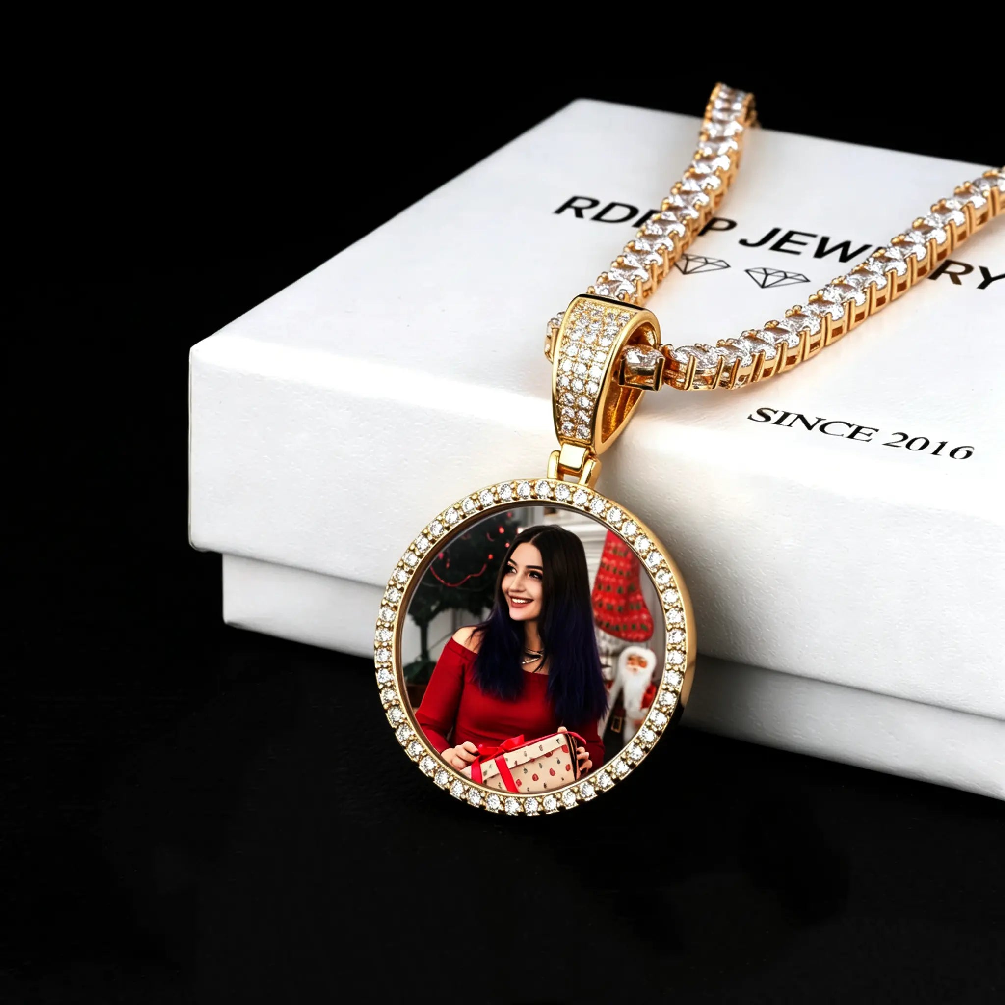 Classic Iced Out Circle Custom Photo Pendant Necklace, yellow gold tone circular pendant with custom woman portrait photo, single row icy stone frame, tennis chain, displayed on RDRIP branded white gift box, black background studio shot, personalized hip hop memory jewelry, RDRIP JEWELRY
