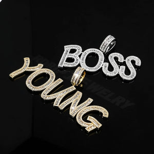 Iced Out Baguette Custom Name Letter Pendant Necklace, flat lay shot on reflective black surface, gold tone "YOUNG" and white gold tone "BOSS" baguette stone letter pendants, customizable hip hop personalized name jewelry, RDRIP JEWELRY watermark, RDRIP JEWELRY
