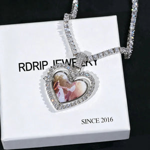 Iced Out Double Sided Rotatable Heart Custom Photo Pendant, white gold tone with tennis chain, wedding couple photo inside heart frame, placed on white RDRIP JEWELRY branded box marked SINCE 2016, dark textured background personalized photo locket necklace, RDRIP JEWELRY
