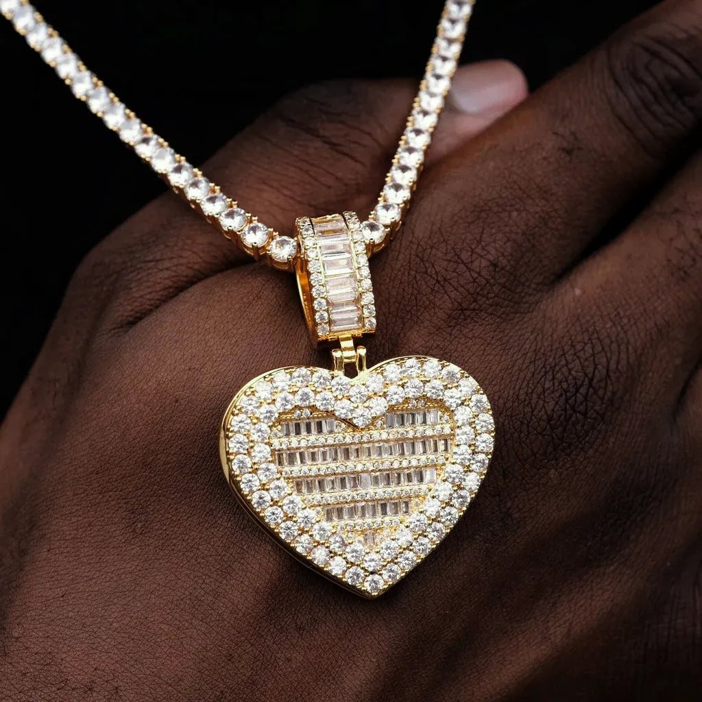 Iced Out Heart Locket Custom Photo Pendant Necklace, gold color closed front view, fully encrusted heart locket with round and baguette cut stones, displayed resting on hand model, tennis chain, solid black background, openable personalized hip hop custom photo keepsake jewelry, RDRIP JEWELRY
