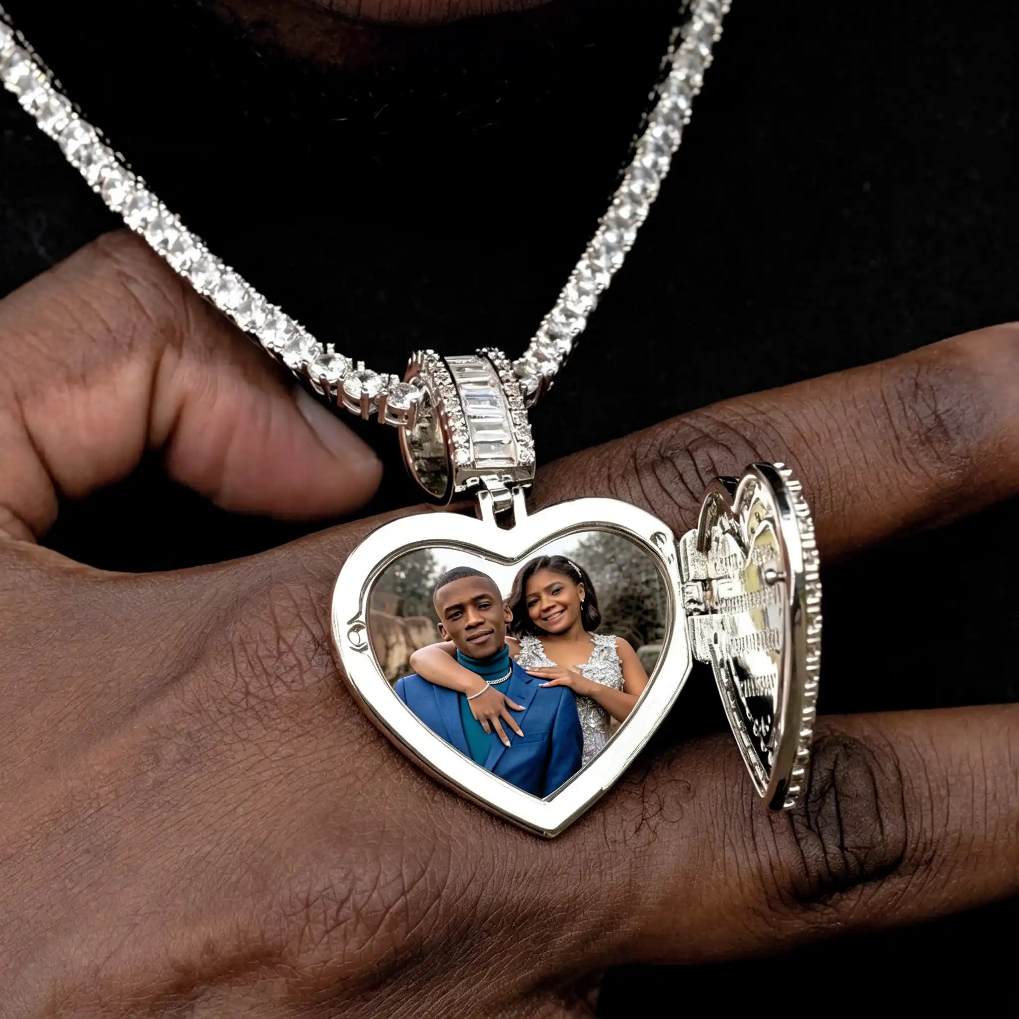 Iced Out Heart Locket Custom Photo Pendant Necklace, gold color open heart locket with custom couple portrait photo inside, displayed resting on hand model, tennis chain, solid black background, subtle glass cover reflection, openable personalized hip hop memory jewelry, RDRIP JEWELRY
