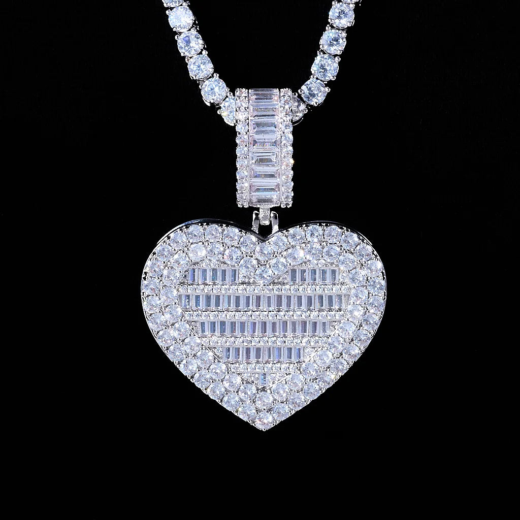 Iced Out Heart Locket Custom Photo Pendant Necklace, white gold tone closed front view, heart-shaped locket covered with round and baguette cut stones, paired tennis chain on solid black background, openable personalized custom photo hip hop jewelry, RDRIP JEWELRY
