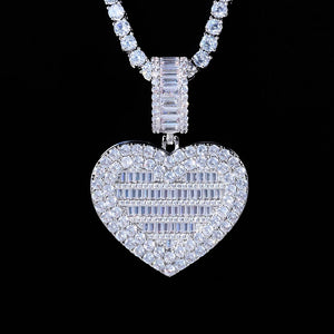 Iced Out Heart Locket Custom Photo Pendant Necklace, white gold tone closed front view, heart-shaped locket covered with round and baguette cut stones, paired tennis chain on solid black background, openable personalized custom photo hip hop jewelry, RDRIP JEWELRY
