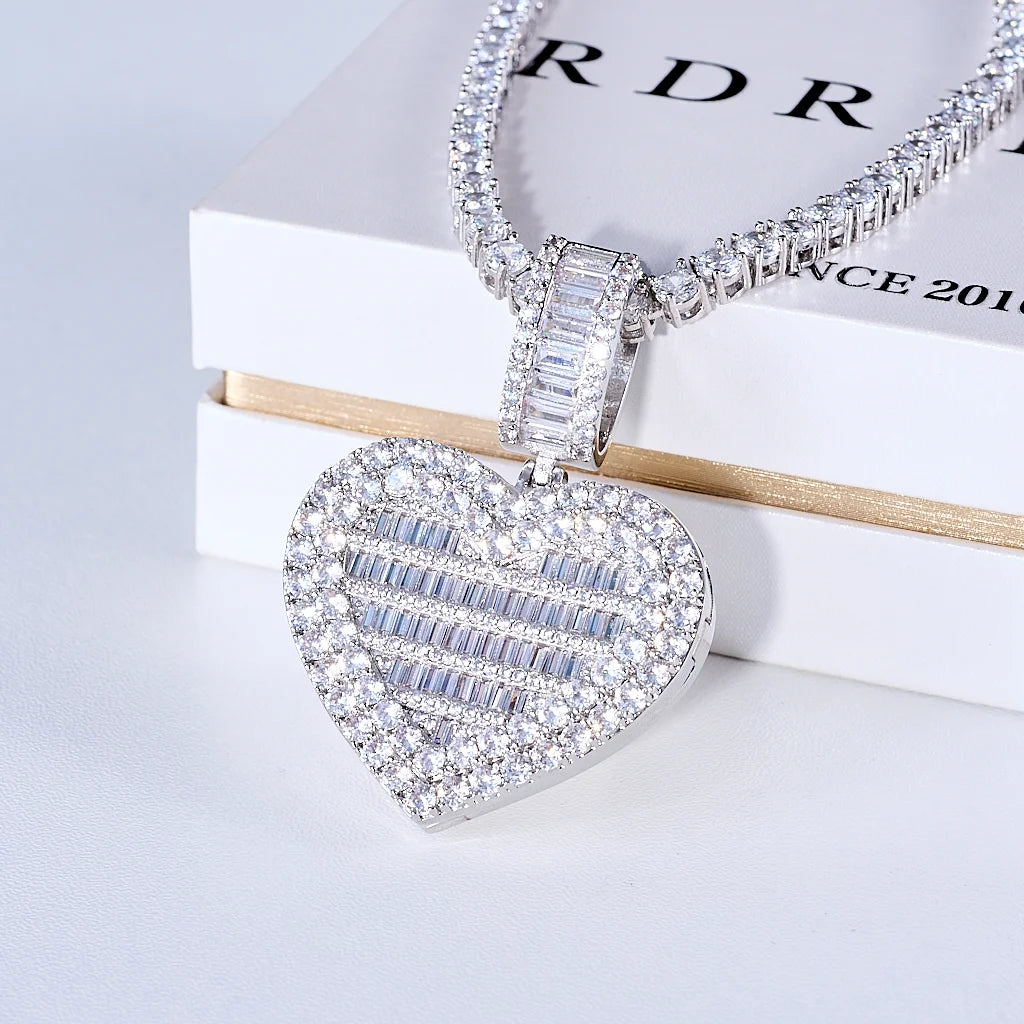 Iced Out Heart Locket Custom Photo Pendant Necklace, white gold tone closed oblique front view, openable heart-shaped locket fully paved with round and baguette cut stones, matching tennis chain displayed on official RDRIP branded white gift box, light background studio commercial shot, personalized hip hop custom photo keepsake jewelry, RDRIP JEWELRY
