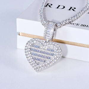 Iced Out Heart Locket Custom Photo Pendant Necklace, white gold tone closed oblique front view, openable heart-shaped locket fully paved with round and baguette cut stones, matching tennis chain displayed on official RDRIP branded white gift box, light background studio commercial shot, personalized hip hop custom photo keepsake jewelry, RDRIP JEWELRY
