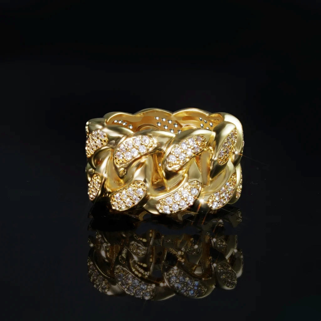Front view shot of iced out miami cuban link men ring, 18k gold plated with micro pave cubic zirconia stones, thick wide hollow band hip hop statement ring, displayed on black reflective background with mirror reflection effect by RDRIP JEWELRY
