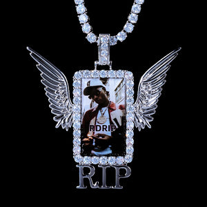 Iced Out Wings RIP Custom Photo Pendant, white gold tone hanging front view, angel wing rectangular photo frame pendant with RIP detail, encrusted round stones, matched tennis chain, solid black background, memorial personalized hip hop keepsake jewelry, RDRIP JEWELRY
