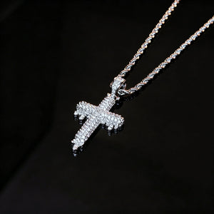 RDRIP JEWELRY SINCE 2016 Close‑up shot of Iced Out Dripping Cross Pendant on black reflective surface, fully micro paved cubic zirconia melting drip cross hip hop necklace, silver twisted rope chain, premium iced streetwear jewelry for men, brilliant sparkling stones detail view

