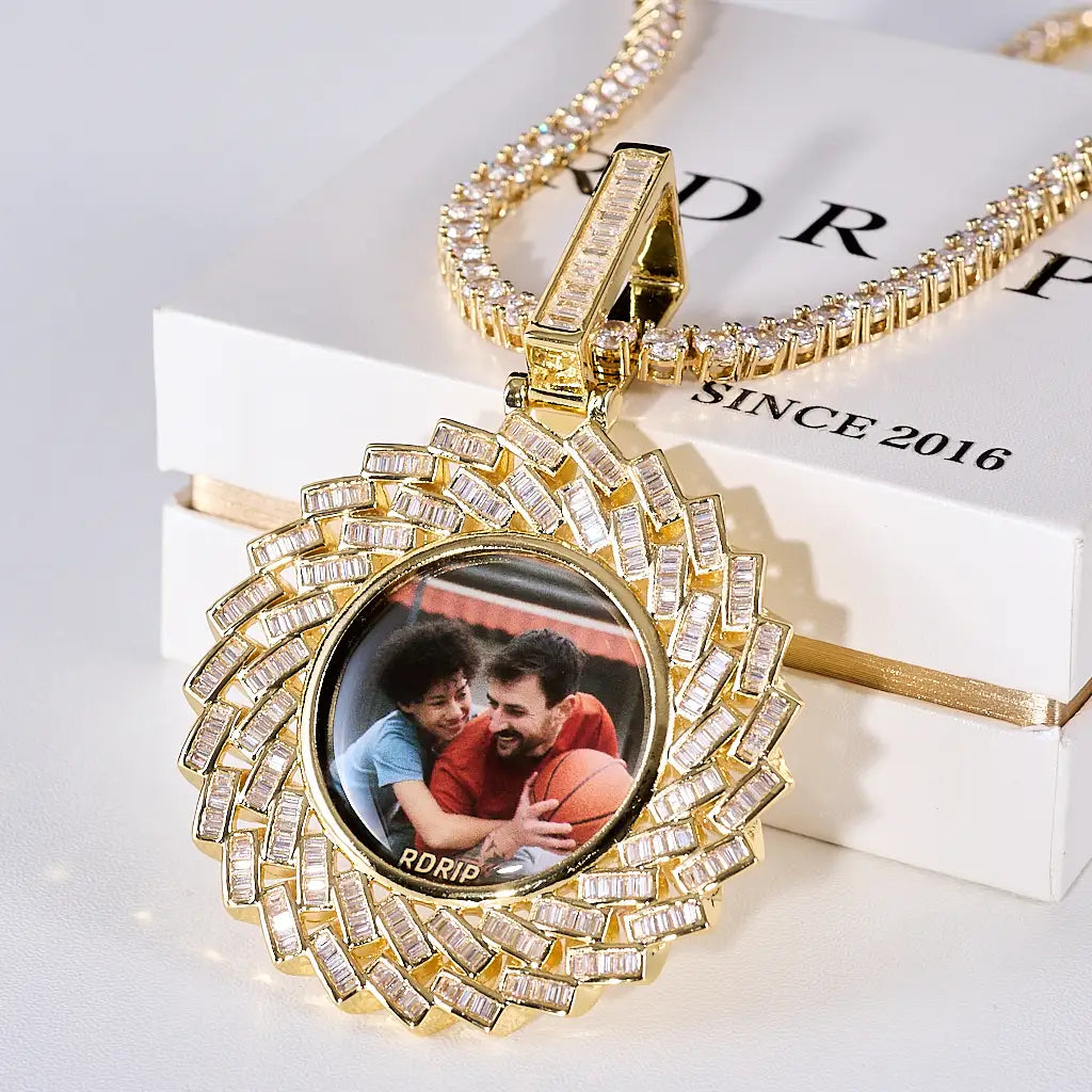 Large 3D Baguette Sunburst Custom Photo Pendant Necklace, gold tone iced out baguette border personalized memory photo medallion with tennis chain, placed on RDRIP branded gift box, studio product shot, RDRIP JEWELRY

